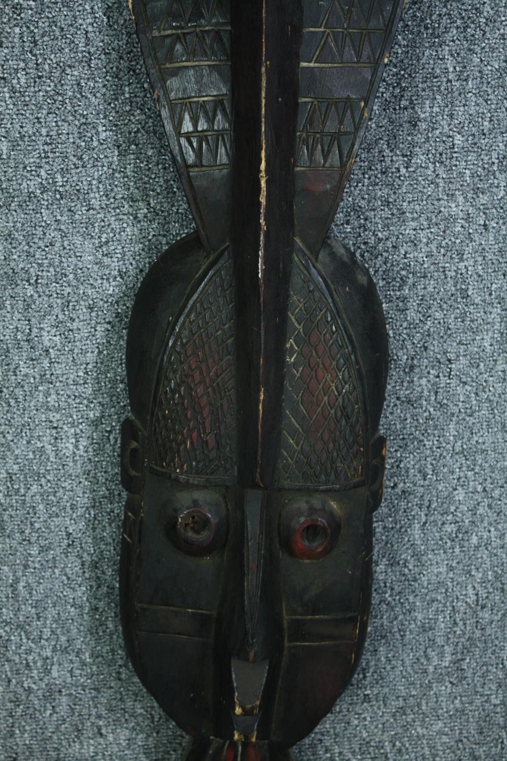 A miscellaneous collection of four carved Eastern and Tribal masks and a carved figure. H.100cm. ( - Image 3 of 6