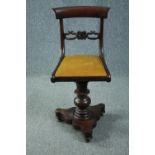 An early Victorian mahogany piano seat with swivel action. H.83cm.