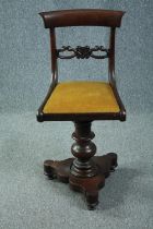 An early Victorian mahogany piano seat with swivel action. H.83cm.