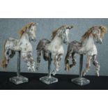 Three carved decorative horse models with articulated limbs. H.53 W.35cm. (each)