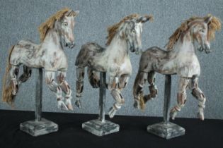 Three carved decorative horse models with articulated limbs. H.53 W.35cm. (each)