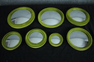 A set of seven graduating 19th century style convex mirrors in velvet effect frames. Dia.23cm. (
