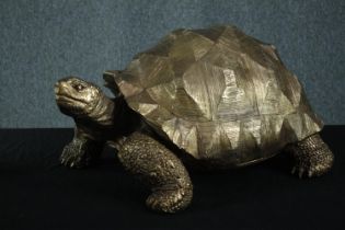A decorative compound tortoise painted in gold. H.33 W.60 D.40 cm.