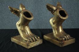 A pair of plastered winged Apollo's feet painted in gold. H.34cm.