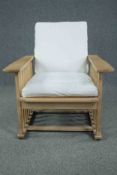 A contemporary Arts and Crafts style oak framed reclining armchair. H.86 W.77 D.86cm.