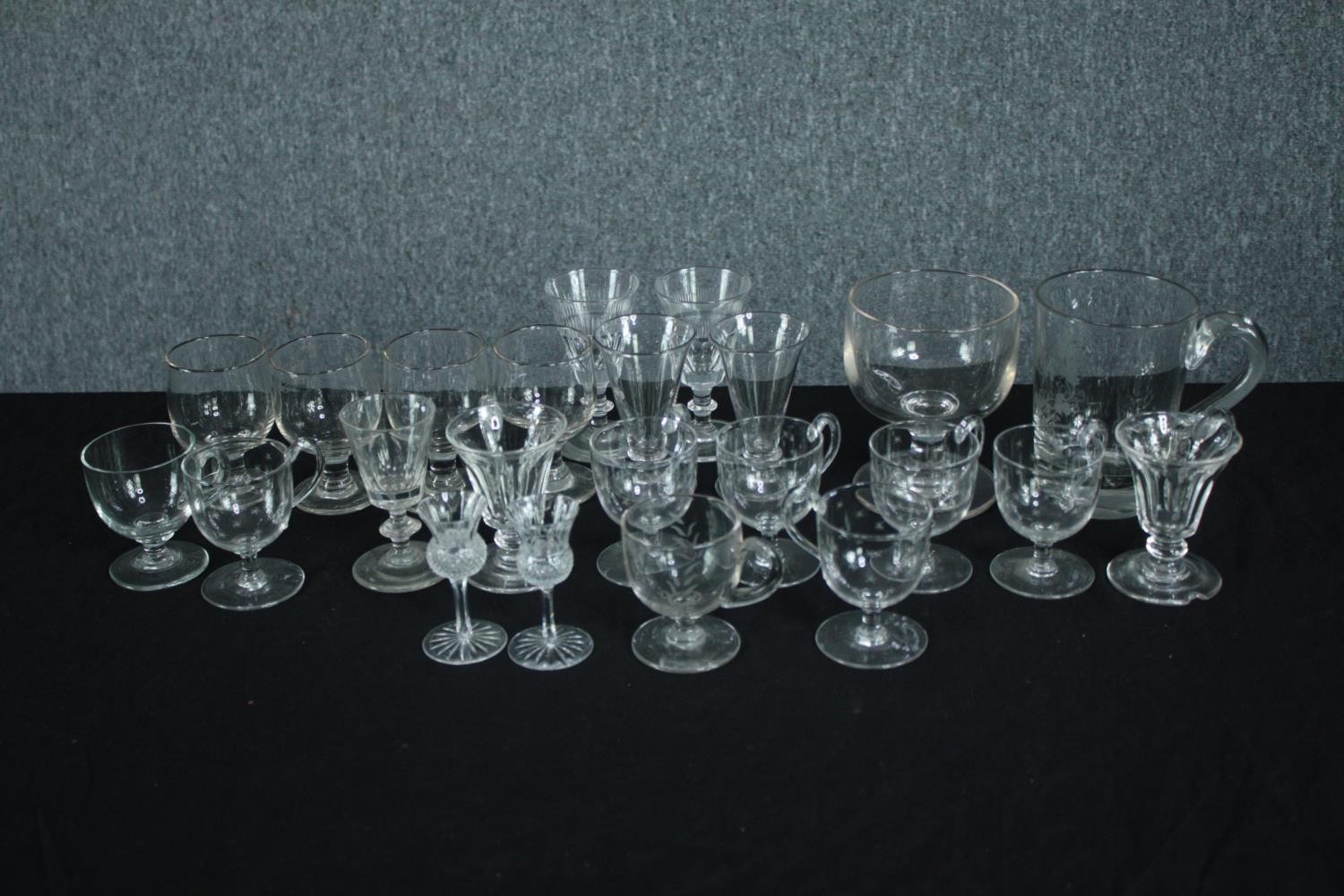 A collection of 19th and early 20th century glasses, including a set of six handled posset glasses