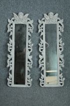 A pair contemporary pier mirrors with floral decorated frames and cherub surmounts. H.80 W.28cm. (