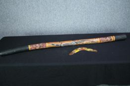 A decorative digeridoo and boomerang. L.137 cm. (largest)