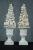 A pair of ceramic sea shell topiary displays in campana urns. H.60cm. (each)
