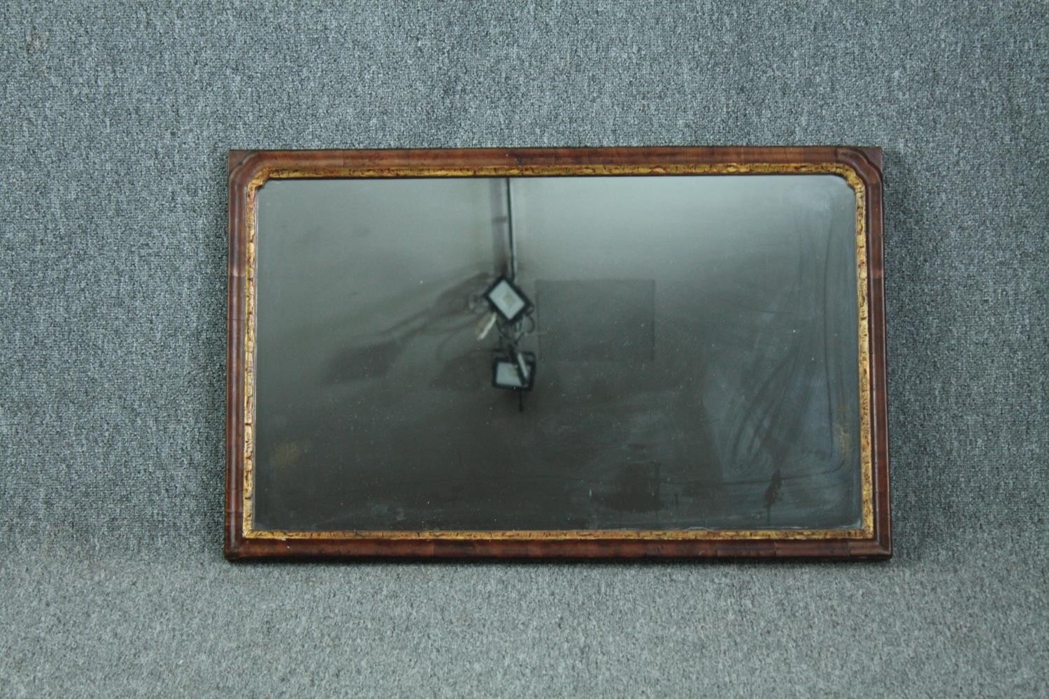 Wall mirror, Georgian walnut framed and parcel gilt. H.48 W.77cm.