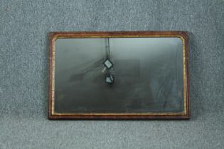 Wall mirror, Georgian walnut framed and parcel gilt. H.48 W.77cm.
