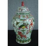 A Chinese lidded pot hand painted and decorated with dragons. Twentieth century. H.58 Dia. 30 cm.