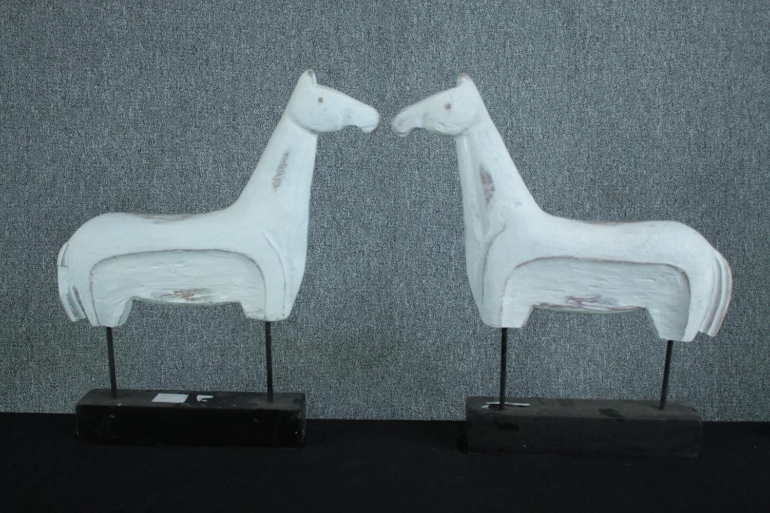 Pair of carved horses painted white. One with damaged base. H.57 w.53cm. (each)
