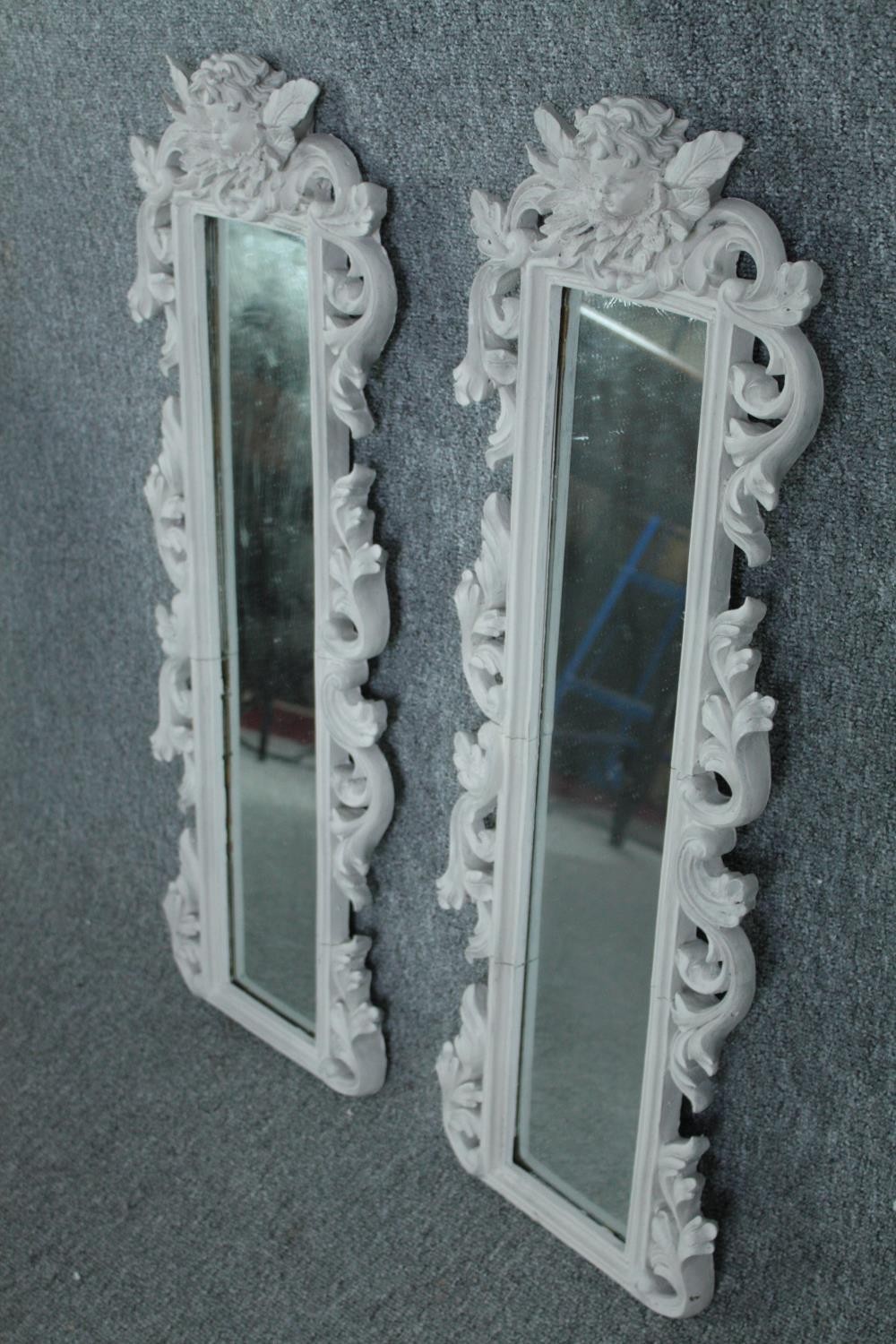 A pair contemporary pier mirrors with floral decorated frames and cherub surmounts. H.80 W.28cm. ( - Image 2 of 5