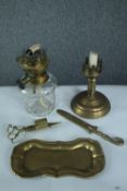 A collection of brass items including an oil lamp, tray, letter opener and scissors. H.23 W.12