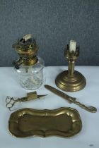 A collection of brass items including an oil lamp, tray, letter opener and scissors. H.23 W.12