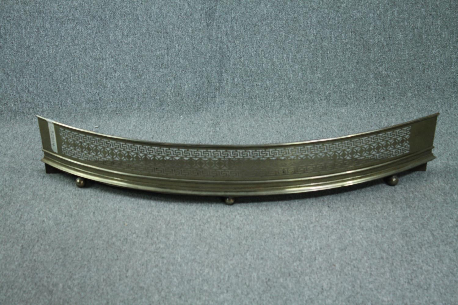 Fire fender, 19th century pierced brass. H.19 W.116cm.