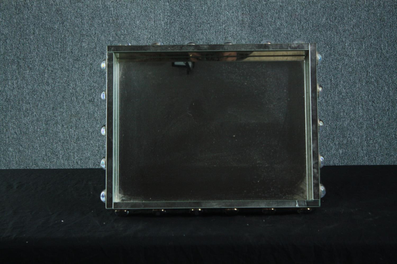 A contemporary industrial style metal framed wall mirror. H.39 W.49cm.