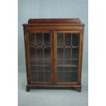 Bookcase, mid century oak with leaded glass doors. H.114 W.90 D.28cm.