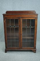 Bookcase, mid century oak with leaded glass doors. H.114 W.90 D.28cm.