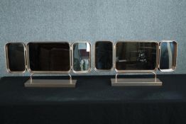 A pair of triptych mirrors in gilt metal frames. H.35 W.67cm. (each).