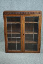 Bookcase, mid century oak with leaded glass doors. H.110 W.90 D.27cm.