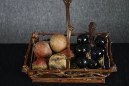 A Victorian Hazelwood basket with a collection of hand painted ceramic fruit and a bunch of glass