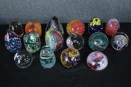 A large collection of modern studio glass paperweights which appear to be made by the same hand.
