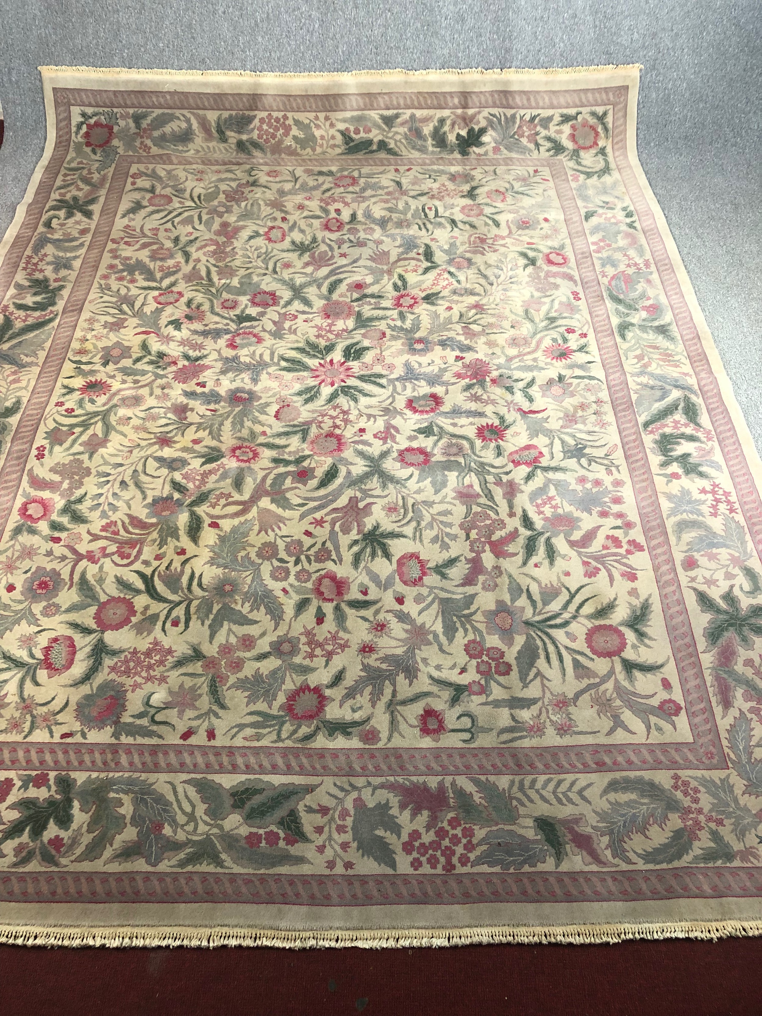 A hand woven carpet with Arts and Crafts flowerhead motifs on a biscuit field within complementary - Image 2 of 5