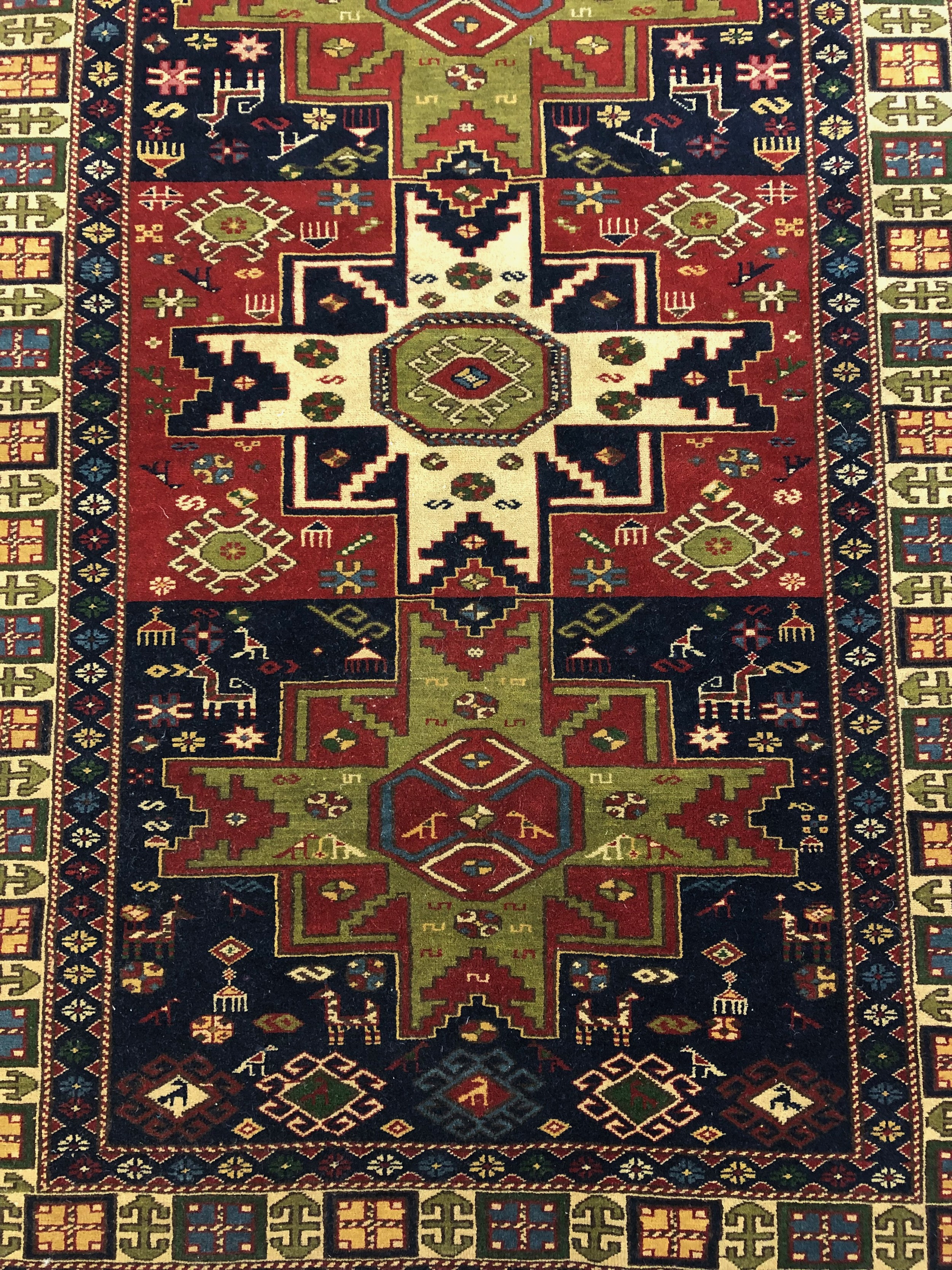 A Shirvan carpet with triple star medallions within stylised borders. L.192 W.129cm. - Image 2 of 3