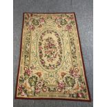 A hand woven silk and wool Aubusson wall hanging tapestry with central floral spray medallion within