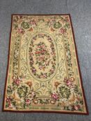 A hand woven silk and wool Aubusson wall hanging tapestry with central floral spray medallion within