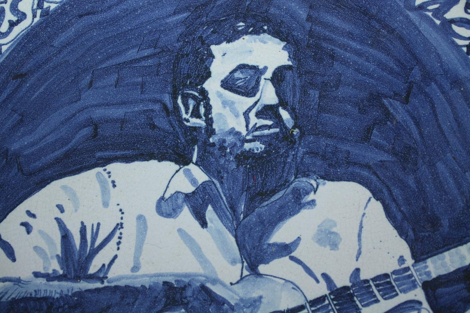 Suzanne Lang. A hand painted ceramic plate featuring a musician Guy Carawan. Guy Hughes Carawan - Image 2 of 4