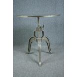 A metal industrial style table with hand winding rise and fall action. Dia.77cm.