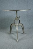 A metal industrial style table with hand winding rise and fall action. Dia.77cm.