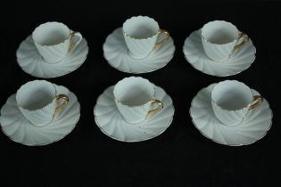 Six white cups and saucers with gilt trim. Twentieth century. H. 5cm. (Largest)