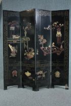 A lacquered Chinese full height four panelled screen with applied hardstone decoration. H.183 W.