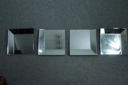 A contemporary wall mirror with glazed frame in four sections. H.42 W.40cm. (each)