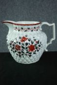 An early 19th century pineapple moulded jug with silver lustre and red enamel floral decoration. H.