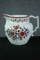 An early 19th century pineapple moulded jug with silver lustre and red enamel floral decoration. H.