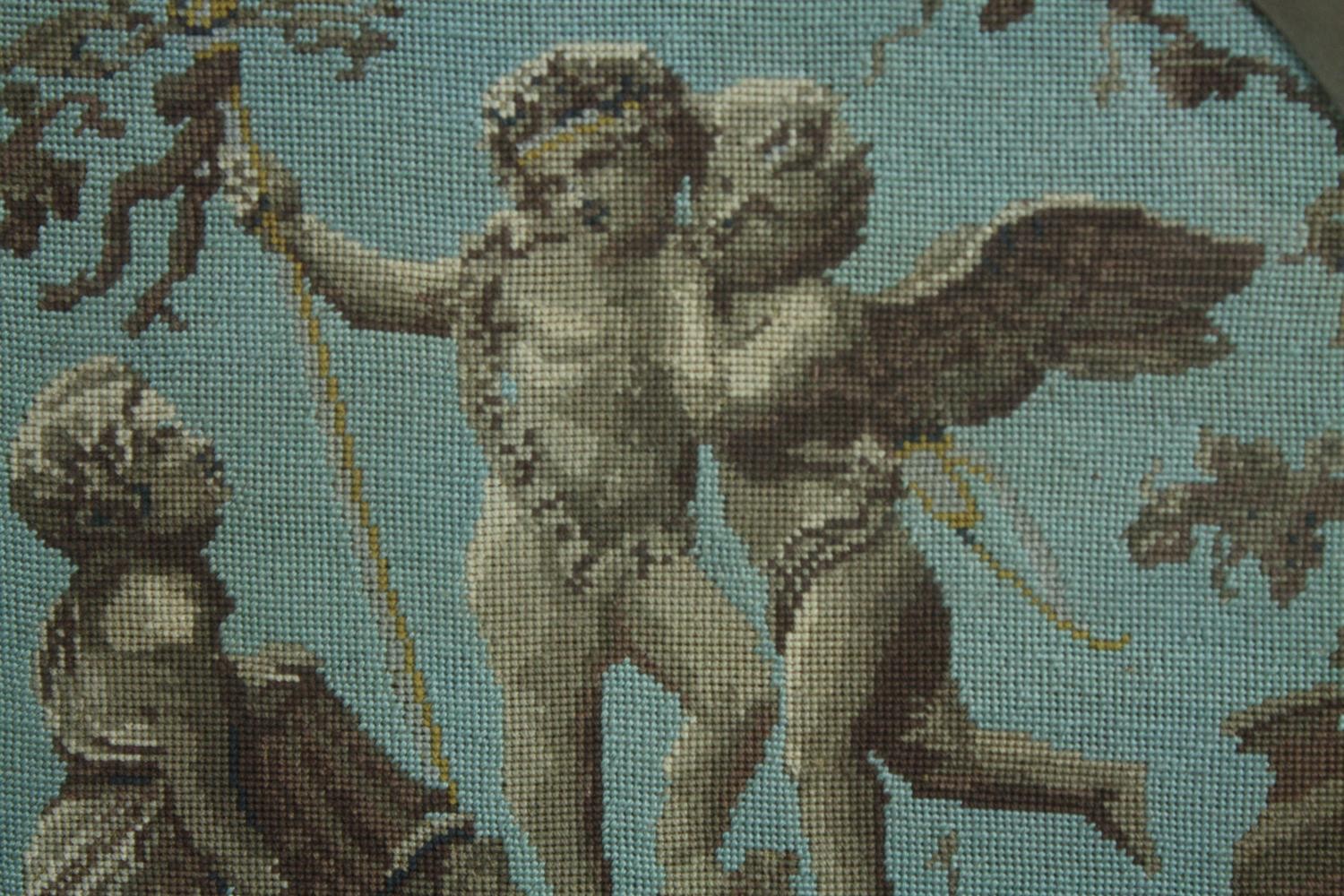 Embroidery. Three classical cherubs. Framed. Nineteenth century. H.50 W.49 cm.