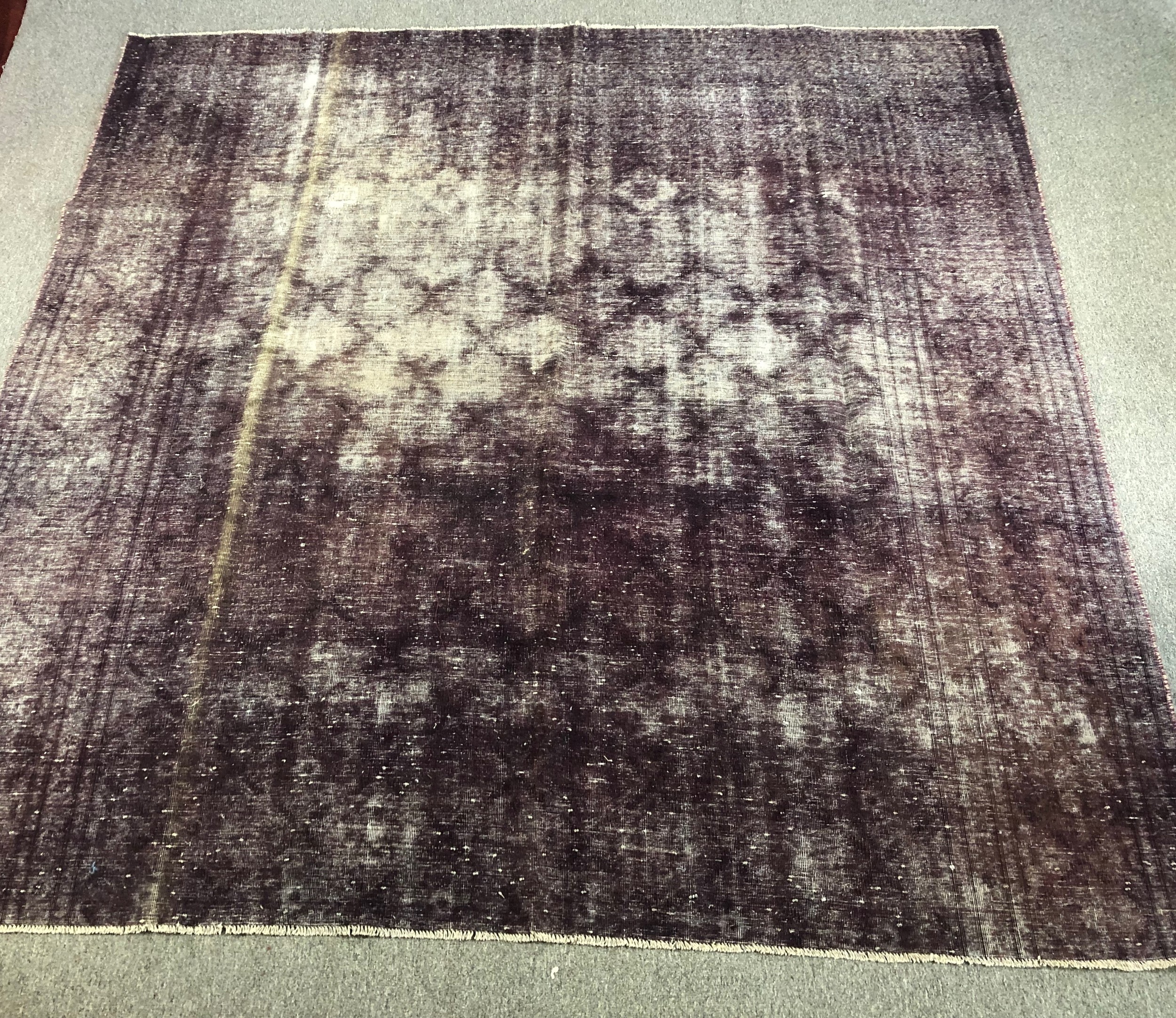 A hand woven Persian carpet, geometric motif across the field, faux distressed. L.276 W.274cm.