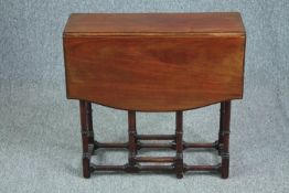 A C.1900 walnut drop flap occasional table. H.58 W.75 D.61cm.