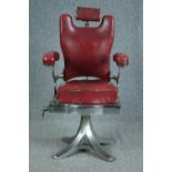 A vintage chromed steel framed barbers chair upholstered in red leather. Solid, well crafted and