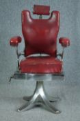 A vintage chromed steel framed barbers chair upholstered in red leather. Solid, well crafted and