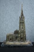 A brass church with steeple on a marble base. Twentieth century. H.34 cm.