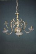 A brass chandelier with three branches of lights. H.50 Dia.57cm.