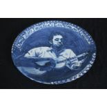 Suzanne Lang. A hand painted ceramic plate featuring a musician Guy Carawan. Guy Hughes Carawan