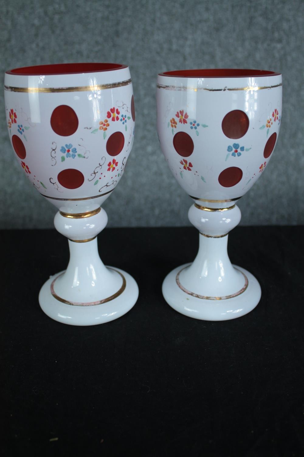 A pair of late 19th century Bohemian cameo glass goblets with hand painted floral decoration. H.20