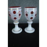 A pair of late 19th century Bohemian cameo glass goblets with hand painted floral decoration. H.20